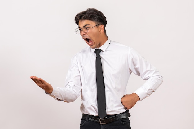 Front view male office worker screaming on white wall work office human job