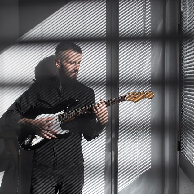 Free Photo front view of male performer playing electric guitar