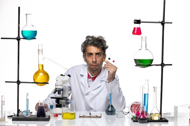 Front view male scientist holding samples on white background coronavirus health lab covid