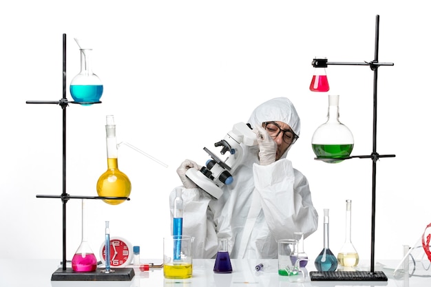 Free photo front view male scientist in special protective suit holding microscope