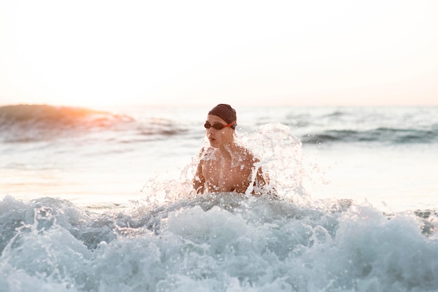 Front view of male swimmer swimming in the ocean