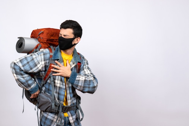 Free photo front view male traveler with backpack and mask holding chest with pain