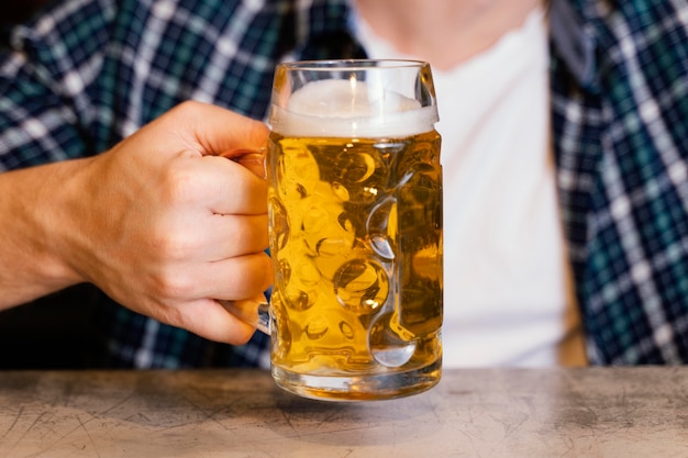 Front view of man celebrating st. patrick's day with drink