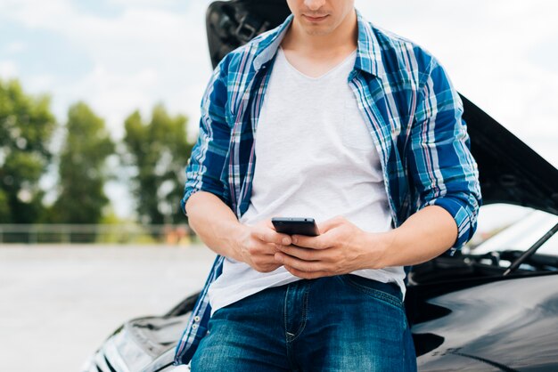 Front view of man checking his phone