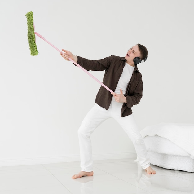 Free photo front view of man cleaning and having fun