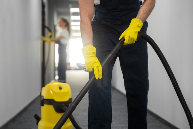 Front view man cleaning indoors