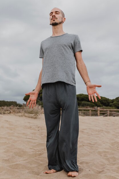 Front view of man doing yoga outdoors