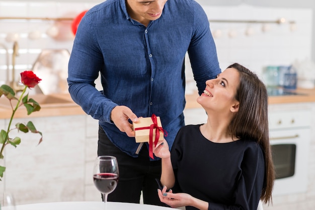 Front view man giving his wife a valentine's day present