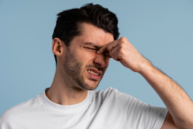 Front view of man having a headache