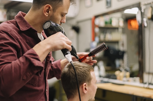 Front view of man having his hair dryed