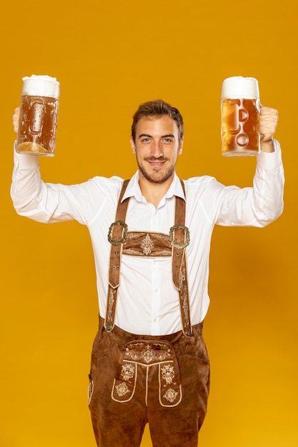 Front view of man holding beer pints