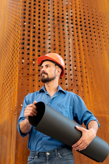 Front view of man holding building plan