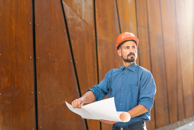 Front view of man holding construction plan