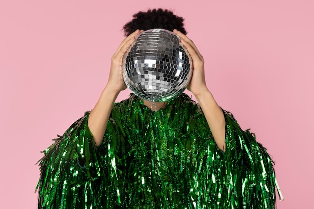 Free Photo front view man holding disco ball