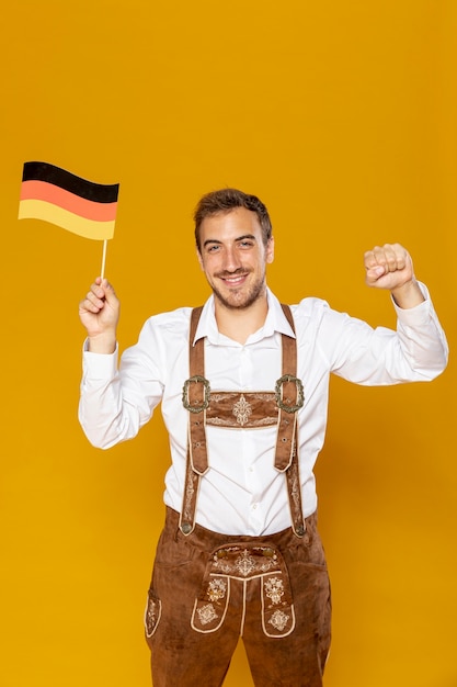 Front view of man holding german flag