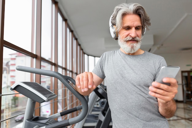 Front view man holding smartphone