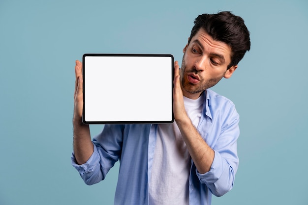 Front view of man holding tablet