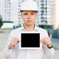 Free photo front view man holding up tablet