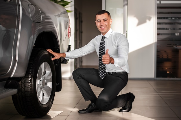 Free photo front view man on one knee showing ok sign