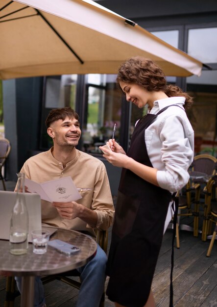 Front view man ordering at restaurant