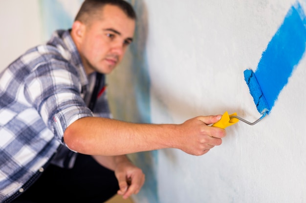 Free Photo front view of man painting a wall