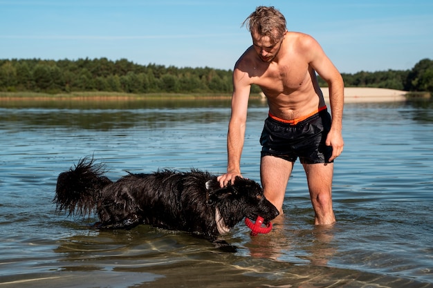 Front view man petting dog