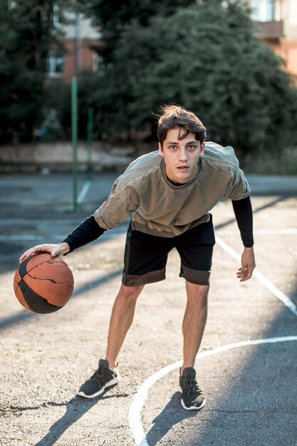 Front view man playing basketball