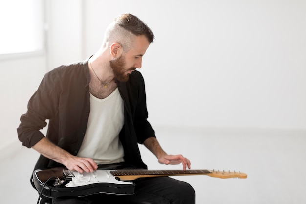 Free Photo front view of man playing electric guitar