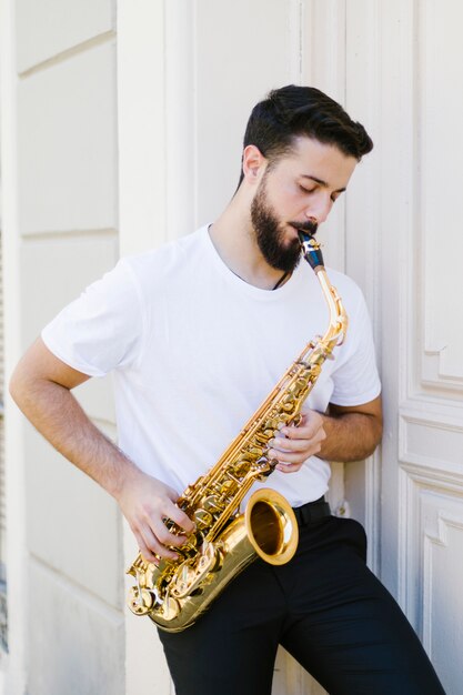 Front view man playing the saxophone