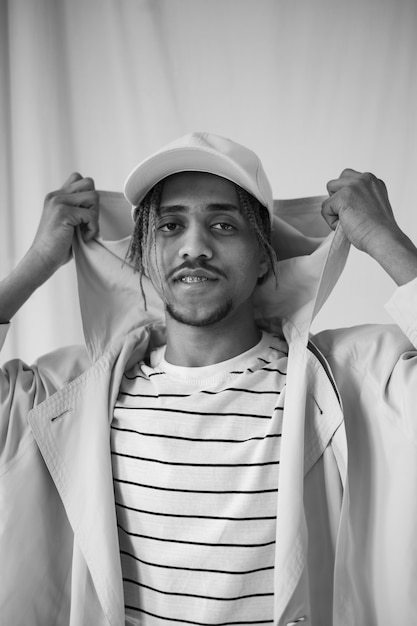 Front view man posing with hat