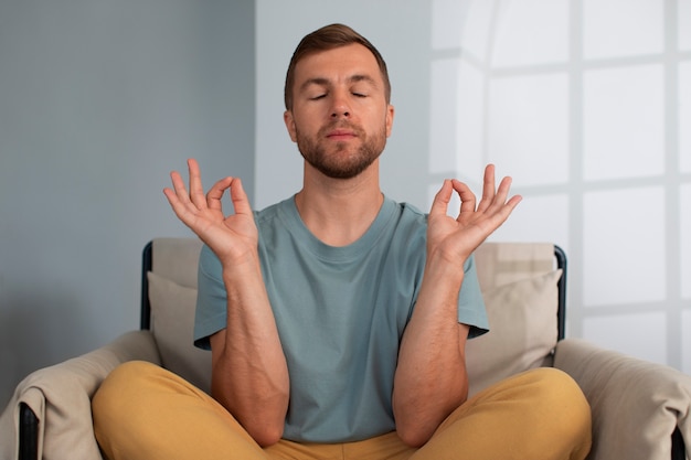 Front view man practicing facial yoga