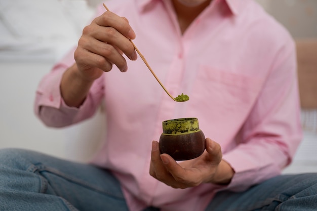 Free Photo front view man preparing matcha tea