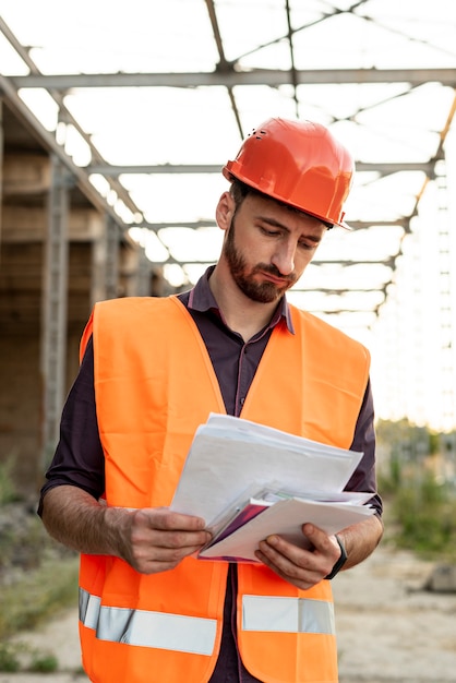 Free photo front view of man reading schematic