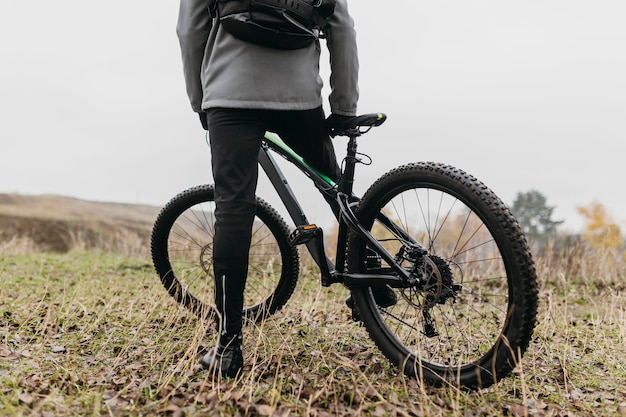 Free photo front view of man riding a bike