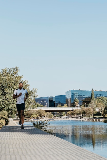 Free Photo front view man running outdoors