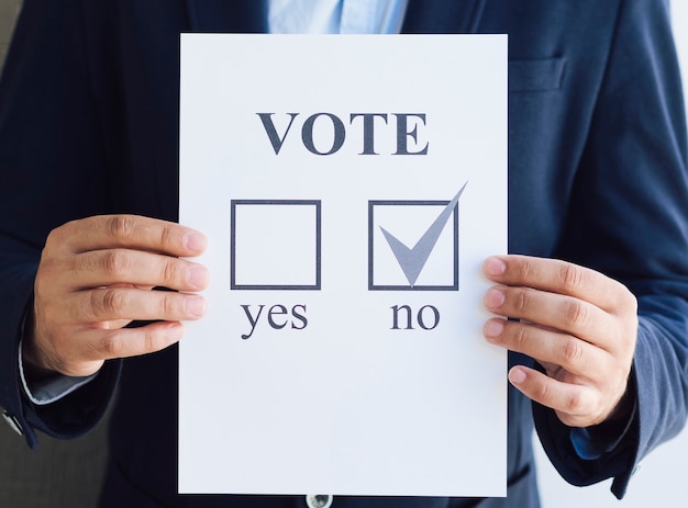 Free photo front view man showing his negative choice for the referendum