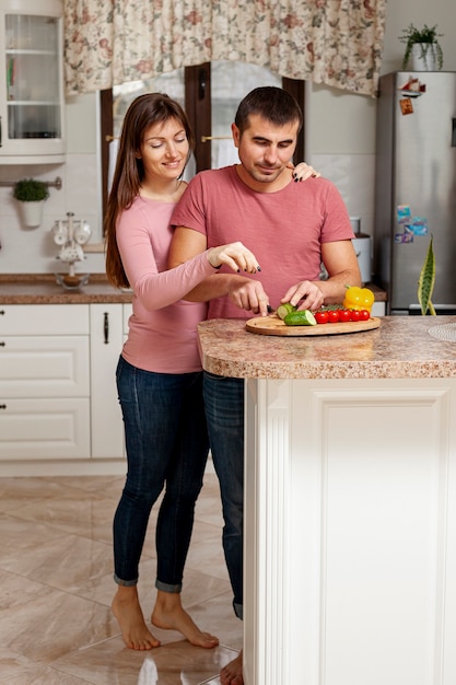 Front view man slicing a cucumber