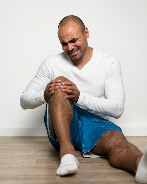 Front view of man suffering from knee pain