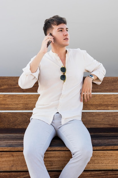 Front view of man talking on the phone outdoors