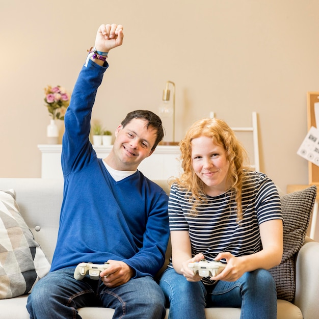 Free Photo front view of man victorious at playing video games against woman