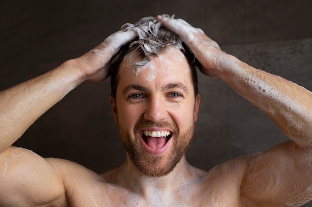 Front view man washing hair