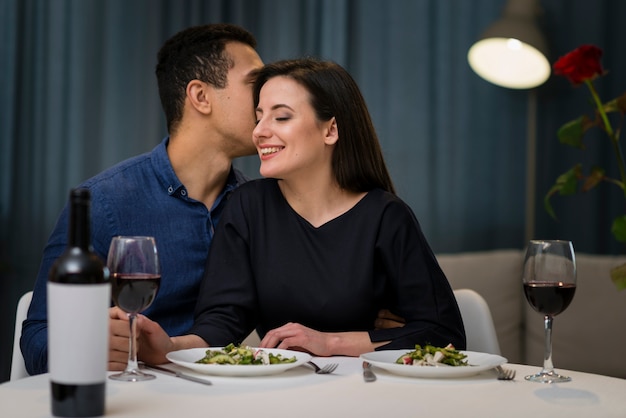 Front view man whispering something to his girlfriend