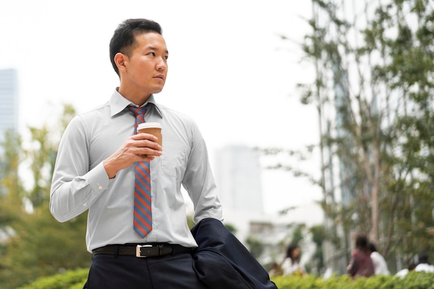 Free photo front view of man with coffee cup