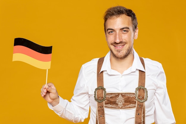 Free photo front view of man with german flag