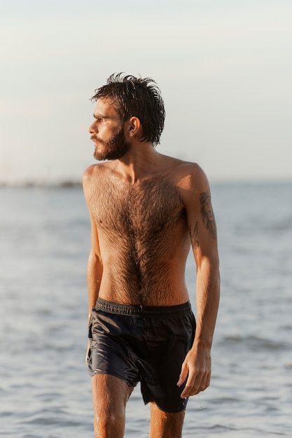 Front view man with hairy chest at seaside