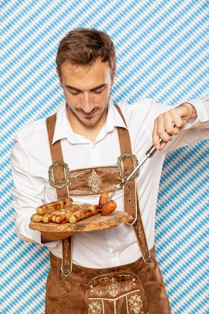 Front view of man with plate of german sausages