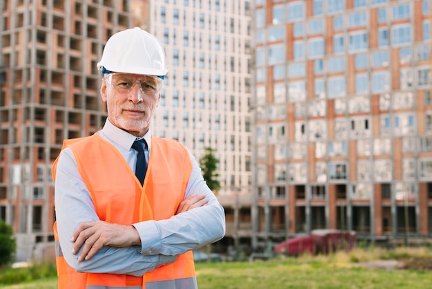 Front view man with safety vest and crossed arms