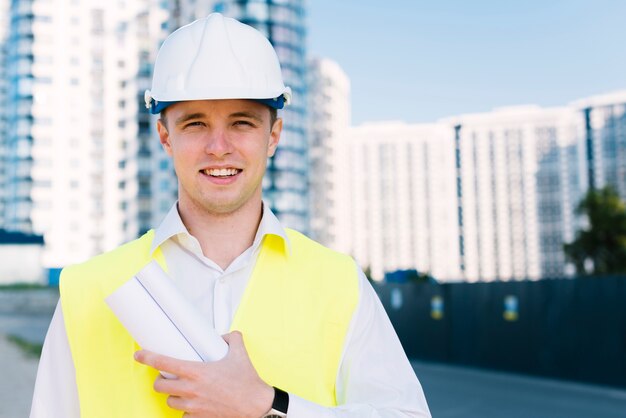 Front view man with safety vest smiling