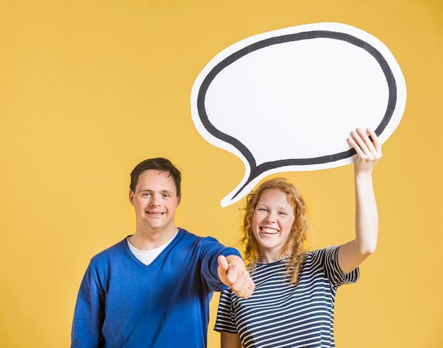 Front view of man and woman holding chat bubble