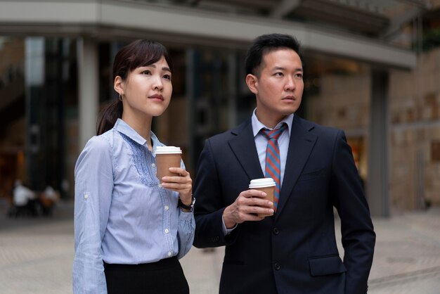 Front view of man and woman with coffee cup